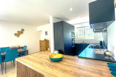 a kitchen with a wooden counter with a blue bowl on it at Villa Amaredda Di Arasu in Sainte-Lucie de Porto-Vecchio