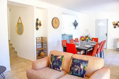 a living room with a couch and a table with chairs at Villa Ditalina Di Arasu in Sainte-Lucie de Porto-Vecchio