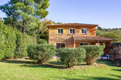 a stone house with bushes in front of it at Villa Ditalina Di Arasu in Sainte-Lucie de Porto-Vecchio
