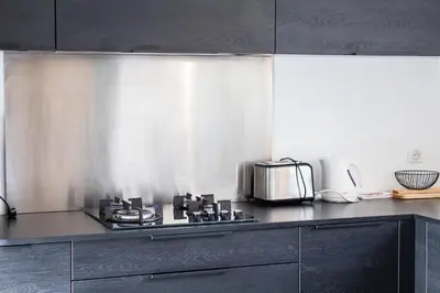 a kitchen with a stove and a toaster oven at Villa Ditalina Di Arasu in Sainte-Lucie de Porto-Vecchio