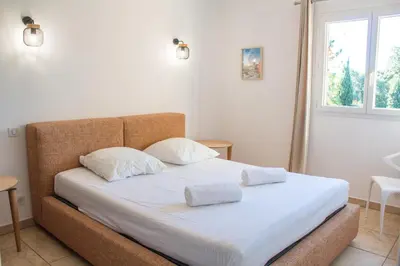 a bedroom with a bed with two pillows on it at Villa Ditalina Di Arasu in Sainte-Lucie de Porto-Vecchio