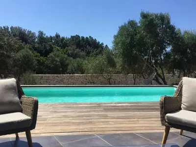 two chairs sitting next to a swimming pool at La Casa Soliam in Bonifacio