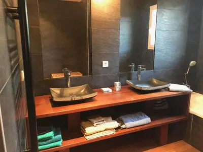 a bathroom with a sink and a mirror at La Casa Soliam in Bonifacio