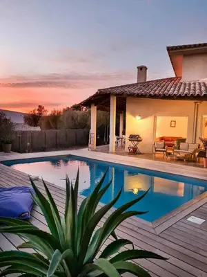 a villa with a swimming pool in front of a house at La Casa Soliam in Bonifacio