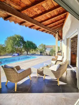 a patio with chairs and a table and a swimming pool at La Casa Soliam in Bonifacio