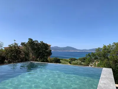 a swimming pool with a view of the ocean at VILLA IMPERIALE vue mer piscine in Pietrosella