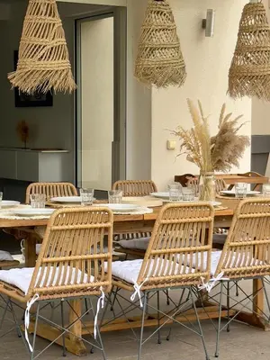 a kitchen and dining room with a table and chairs at VillaSerenita Piscine chauffée, Jacuzzi, Pétanque in Ajaccio