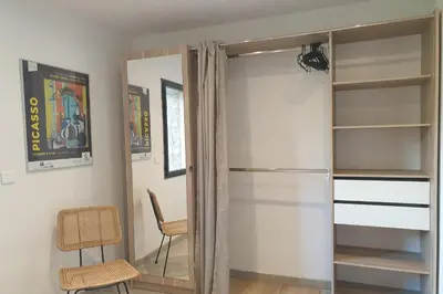 a sliding glass door in a room with a chair at U Caseddu di a Castagna Maison en pierre La Castagna Coti Chiavari in Coti-Chiavari