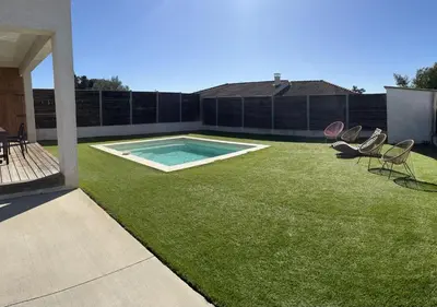 a backyard with a swimming pool and chairs on the grass at Maison de Vacances Avec Piscine Privée en Corse, BORGO in Borgo