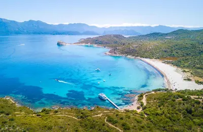 an aerial view of a beach with boats in the water at Casa Mulinchese entre Mer et Montagne in Volpajola