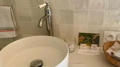 a bathroom counter with a sink and a faucet at Casa1850 in Lama