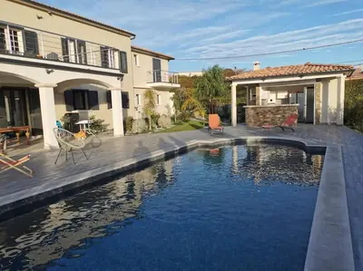 a house with a swimming pool in front of a house at Rez de maison neuve Piscine WiFi Poolhouse en Pierre in Penta-di-Casinca