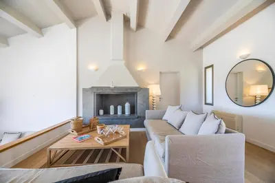 a living room with a couch and a fireplace at Superbe Villa Porto Vecchio vue mer plage à pied in Porto-Vecchio