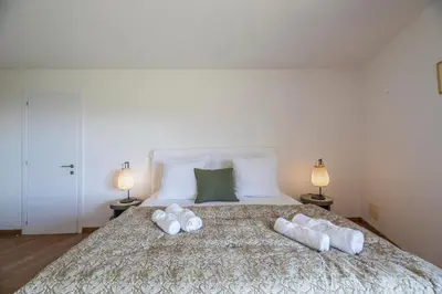 a bedroom with a bed with two towels on it at Superbe Villa Porto Vecchio vue mer plage à pied in Porto-Vecchio
