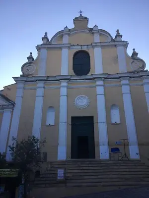 a large building with stairs and a clock on it at Soleil & mer sur la Costa Verde in Cervione