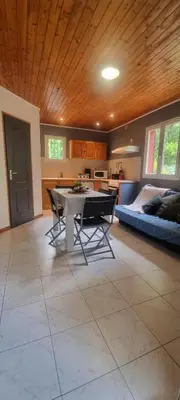 a living room with a table and a bed at Résidence bord de mer I Querci in Poggio-Mezzana