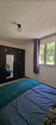 a bedroom with a large bed and a window at Résidence bord de mer I Querci in Poggio-Mezzana
