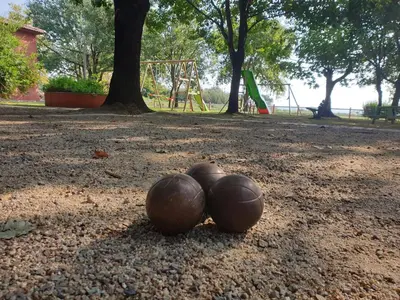 three balls laying on the ground in a park at Résidence bord de mer I Querci in Poggio-Mezzana