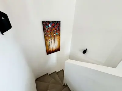 a painting on the wall in a white room at Casamea - Villa Familiale, Piscine, 15 min Ajaccio in Alata