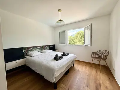 a bedroom with a bed with two teddy bears on it at Casamea - Villa Familiale, Piscine, 15 min Ajaccio in Alata