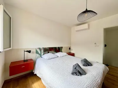a bedroom with a bed with two towels on it at Casamea - Villa Familiale, Piscine, 15 min Ajaccio in Alata