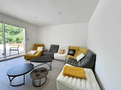 a living room with a couch and a table at Casamea - Villa Familiale, Piscine, 15 min Ajaccio in Alata