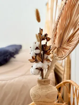 a vase with a plant in it next to a couch at Rare grand appartement standing terrasse et jardin - Porticcio proche mer in Porticcio