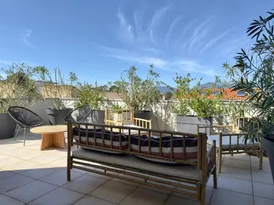 a small boat sitting on top of a patio at Rare grand appartement standing terrasse et jardin - Porticcio proche mer in Porticcio