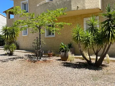 a house with trees and plants in front of it at Rez de chaussez de villa 4 personnes mer in Sorbo-Ocagnano