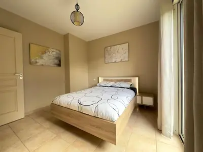 a bedroom with a bed in a room at 72 m2 Centre-ville avec jardin in Porto-Vecchio
