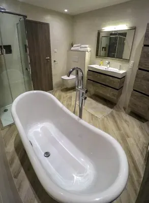a bathroom with a tub and a sink and a toilet at PORTICCIO Maison vue mer in Porticcio