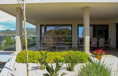a house with a balcony with a view at PORTICCIO Maison vue mer in Porticcio