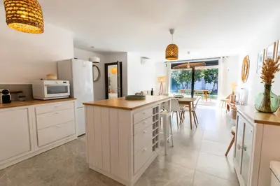 a kitchen with white cabinets and a counter top at Appartement 4-6 pers Bonifacio in Bonifacio