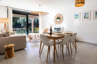 a dining room and living room with a table and chairs at Appartement 4-6 pers Bonifacio in Bonifacio