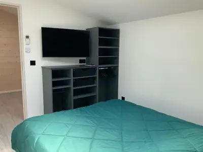 a bedroom with a bed and a flat screen tv at Villa STEVAN in Bonifacio