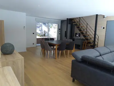 a living room with a couch and a table and chairs at Villa STEVAN in Bonifacio