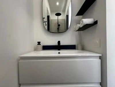 a bathroom with a white sink and a mirror at Superbe studio centre Ajaccio in Ajaccio