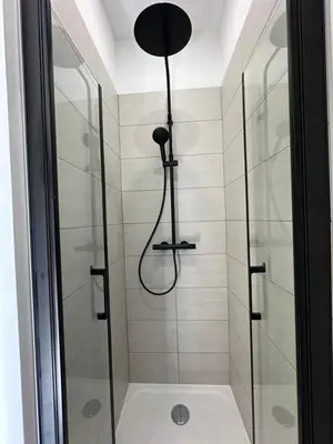 a bathroom with a shower with a glass door at Superbe studio centre Ajaccio in Ajaccio