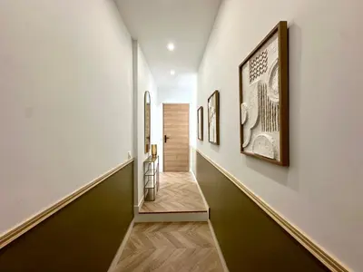a hallway with paintings on the walls at Superbe studio centre Ajaccio in Ajaccio