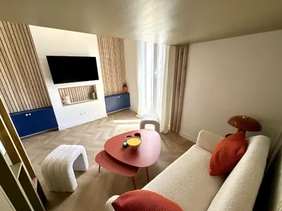 a living room with a couch and a table at Superbe studio centre Ajaccio in Ajaccio