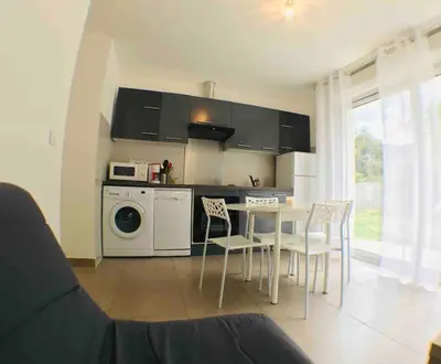 a kitchen with a table and chairs in a room at Casa Bartoli, T2 Entre Mer et Montagne in Isolaccio-di-Fiumorbo