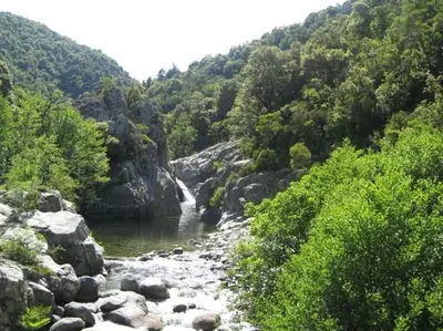 a river with a waterfall in the middle of a mountain at Casa Bartoli, T2 Entre Mer et Montagne in Isolaccio-di-Fiumorbo