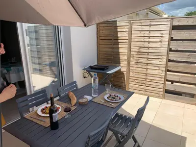 a blue table with food and wine on a balcony at Appartement T3 en Corse, Marina di Bravone N131 in Linguizzetta