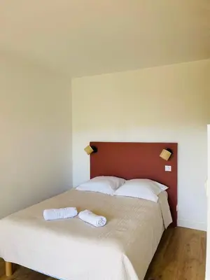 a bedroom with a bed with two towels on it at Appartement l'orée du bois Ajaccio in Ajaccio