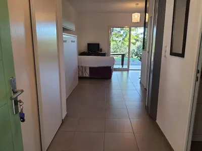 a hallway with a room with a bed and a door at Appart, piscine, proche plage in Lecci