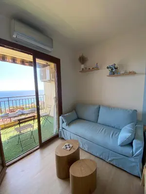 a bedroom with a bed with a view of the ocean at VUE MER EXCEPTIONNELLE !! Studio calme et lumineux sur la prestigieuse route des Sanguinaires à Ajaccio in Ajaccio