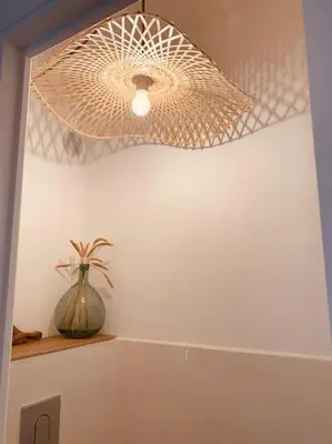 a ceiling light with a flower vase on a shelf at Duplex pour 2 à 6 personnes avec terrasse en plein cœur de la citadelle de Bonifacio in Bonifacio