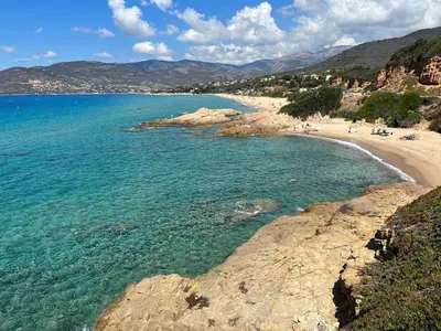a view of a beach with people in the water at Appartement Tour d'Omigna Cargèse in Cargèse