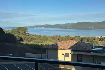 a building with a view of a body of water at Appartement récent, tout confort , vue mer, plage à 5min in Propriano