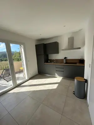 a large kitchen with a large window and a view at Bergerie avec spa vue montagne in San-Nicolao